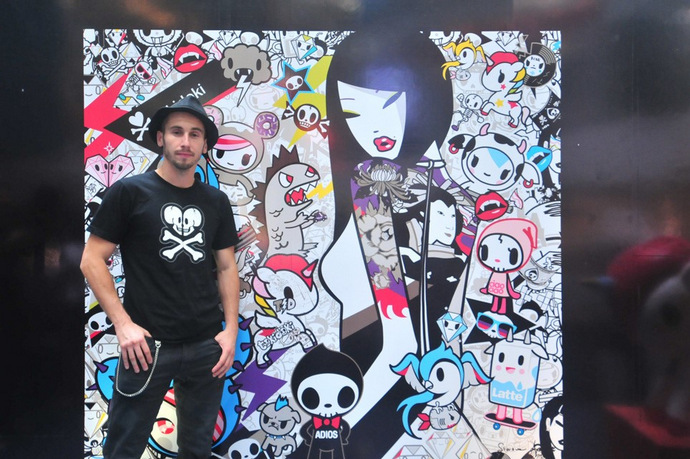 STGCC 2015 Simone Leggo stands proud in front of a tokidoki mural. Credits: tokidoki.it