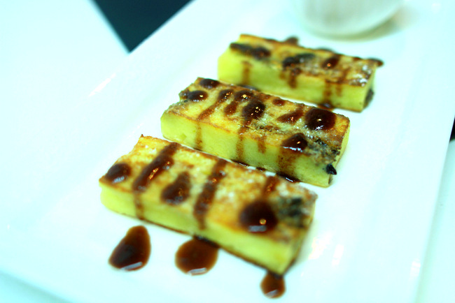 Delectable Fried Bread and Butter Pudding, White Chocolate, Date Syrup and Vanilla Ice Cream.