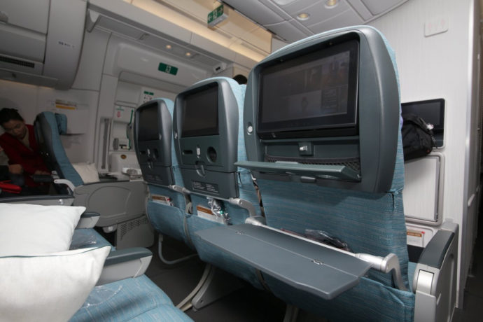 Ecnoomy Class onboard Cathay Pacific's Airbus A350 aircraft with separate tray table for meals and another tray for tablets, handphones and a drink.