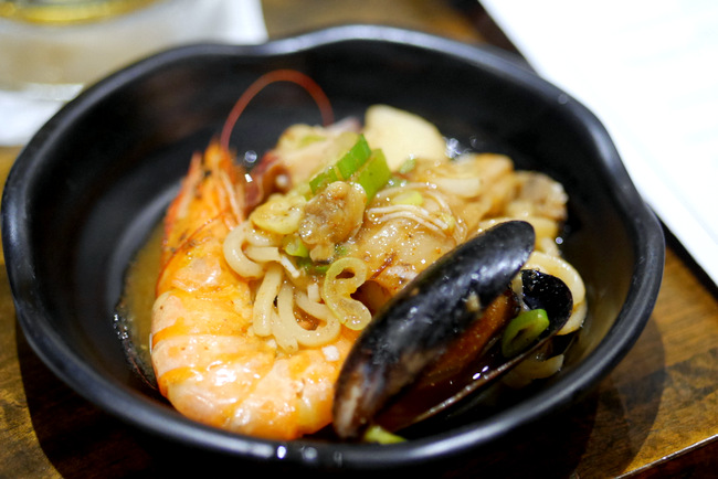 Close-up of the Spicy Seafood Stew (S$36.80) with squid, mussels, crayfish, and prawns cooked in Masizzim secret recipe sauce. It is customisable with 4 levels of spice and comes with either glass noodles or Korean udon.