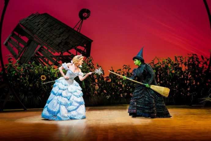 Carley Anderson as Glinda and Jacqueline Hughes as Elphaba in Wicked. (Credit: Wicked)