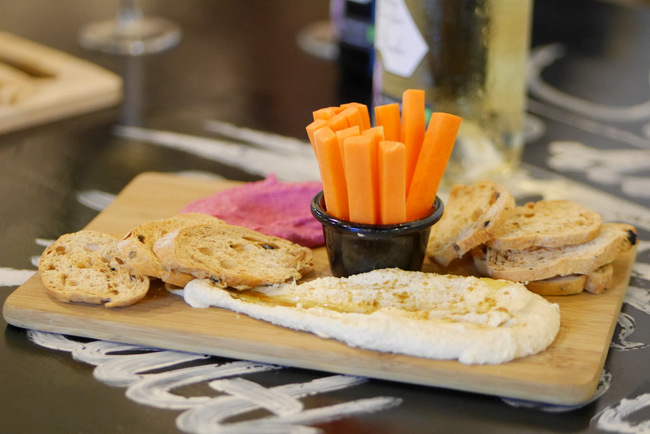 Kitchen by Food Rebel presents House-Made Hummus Dip: beetroot and house-fresh dips with olive toasts and carrot sticks (vegan, dairy free and nut free) (S).