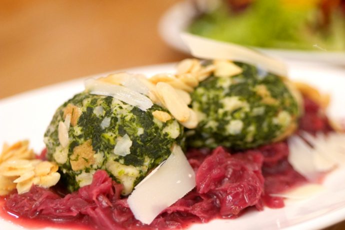 Brez'n serves true Bavarian dishes, including the Spinatknodel : a spinach and bread dumpling on braised red cabbage with butter roasted almonds and cheese shavings.