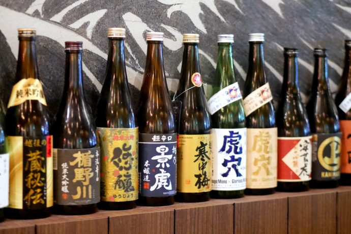 Shukuu Izakaya is decorated with bottles and bottles of sake.