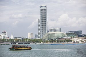 A Singapore River Taxi with Swissotel Singapore and the Esplanade in the background.