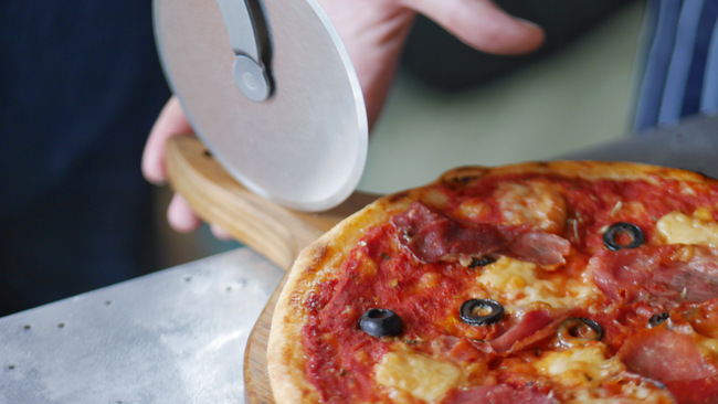 After the pizza is baked, it will be served pipping hot to your station.