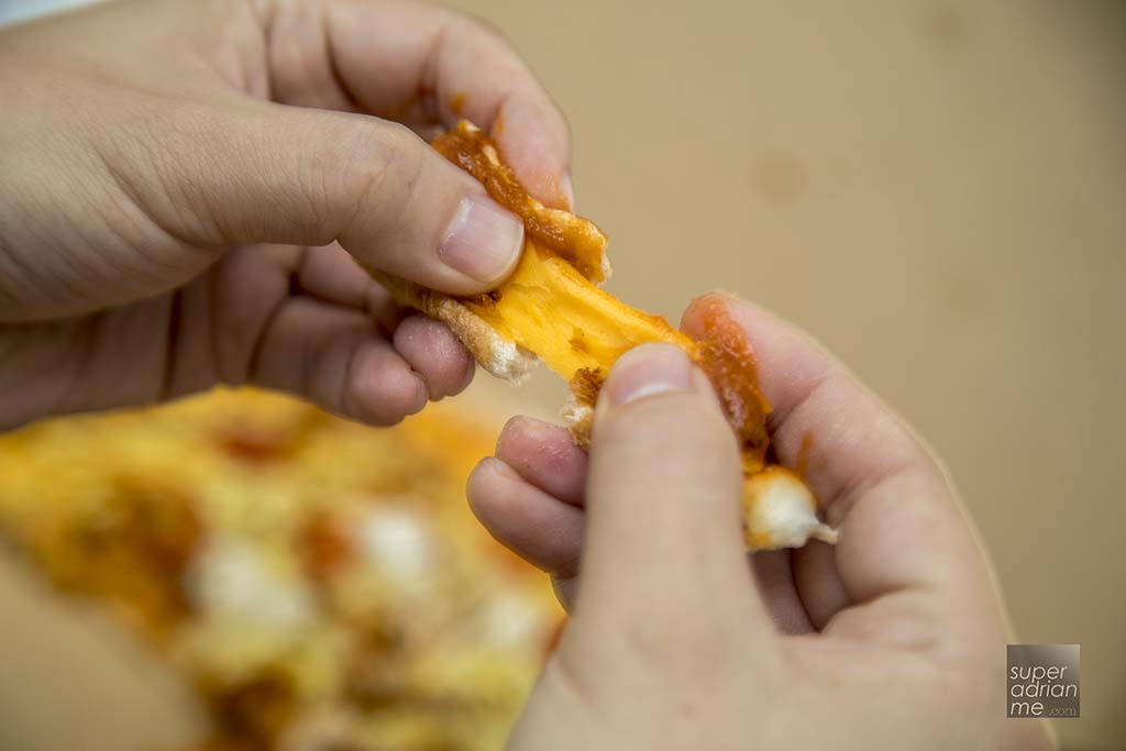 Savoury cheddar and mozzarella in the crust edge of Domino's Pizza