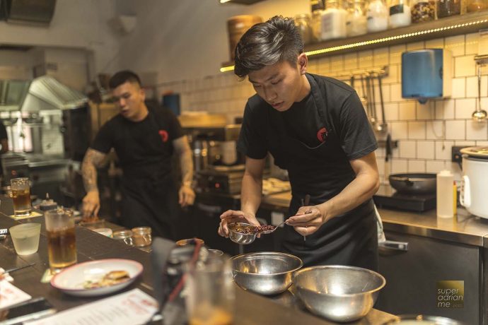 Sit by the bar and see the chefs and bar tender at work at Zui Hong Lou