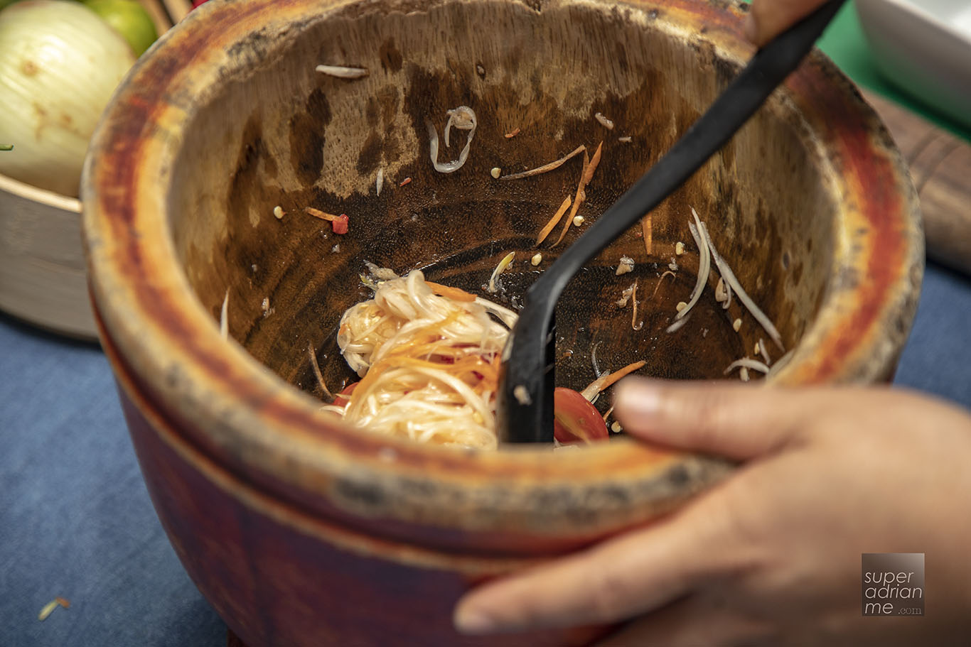 Som Tam Goong - Add ingredients into a Mortar to pestle and toss 