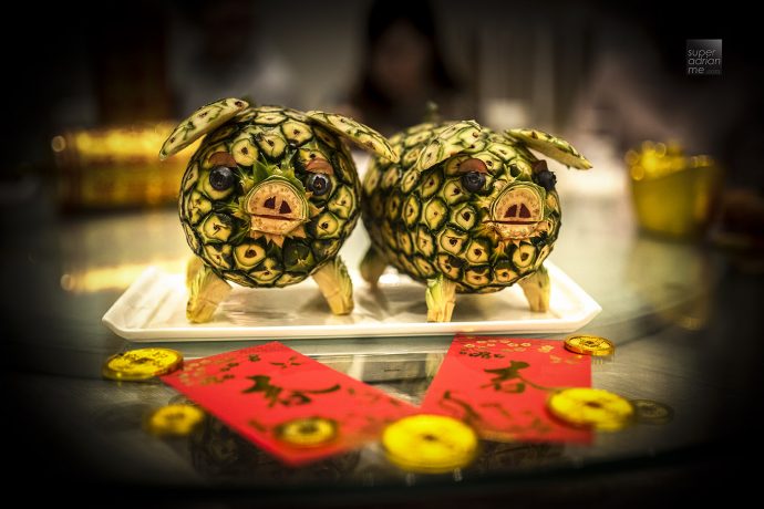 Pigs carved out from a pineapple at Jade to herald the year of the Pig