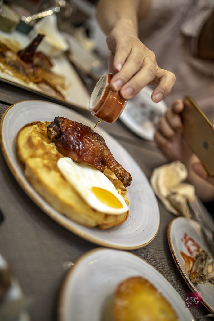 Duckland - Duck and Waffles with Maple Syrup and a sunny side up.