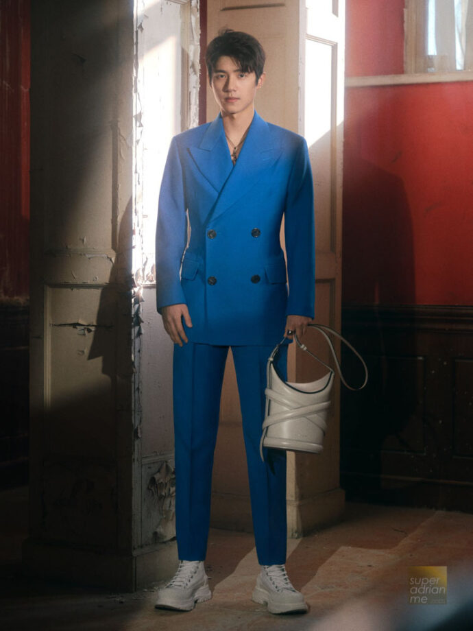 Double-breasted tailored jacket with large lapels and two pleat peg trousers in cerulean blue wool with The Curve and Tread Slicks. (Alexander McQueen photo)