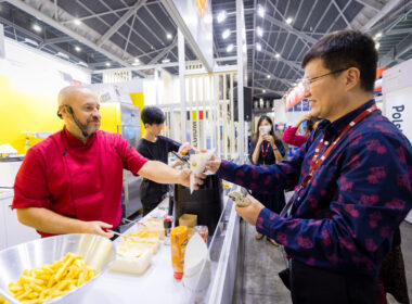 Belgian Chef, Bart Sablon, serving a cone of the Original Belgian Fries at the Food & Hotel Asia Singapore