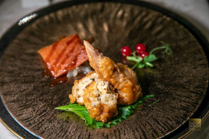 Combination of Sliced Crispy Barbecued Suckling Pig and Bird's Nest, Fresh Crab Meat, Dried Scallops and Truffle Stuffed in Chicken Wing