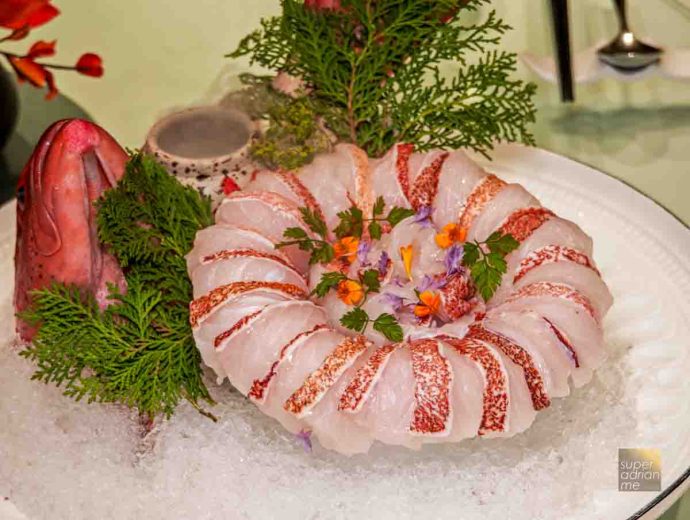 Wild Coral Trout Poached in Hot & Sour Tomato Broth served tableside (S per 100g)