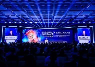 Large conference stage bathed in blue lights with a central screen displaying 2025 WICL and Chinese text; audience seated in front.