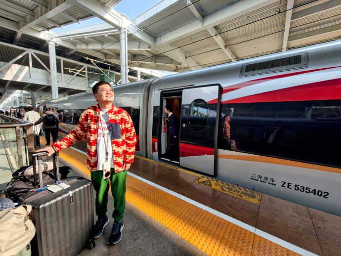 SUPERADRIANME Editor in Qinhuandao Railway Station posing with a highspeed rail.