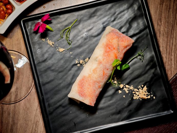 Whole traditional Hokkien popiah served on a black plate | SUPERADRIANME.com Whole traditional Hokkien popiah served on a black plate