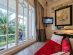 SUPERADRIANME – JW Marriott Phu Quoc Emerald Bay – July 2026 -174734 Bed over looks balcony and view at JW Marriott Phu Quoc Emerald Bay