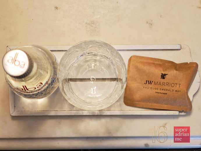 SUPERADRIANME - JW Marriott Phu Quoc Emerald Bay - July 2026 -175736 | SUPERADRIANME.com Mineral Water and Dried Kumquat bedside amenity at JW Marriott Phu Quoc Emerald Bay